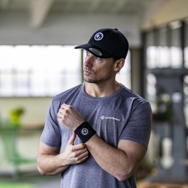 A man wears a black CycleMasters cap, t-shirt and sweatband