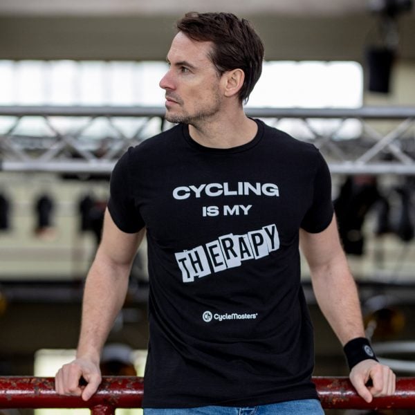 A man wears a black CycleMasters t-shirt and sweatband